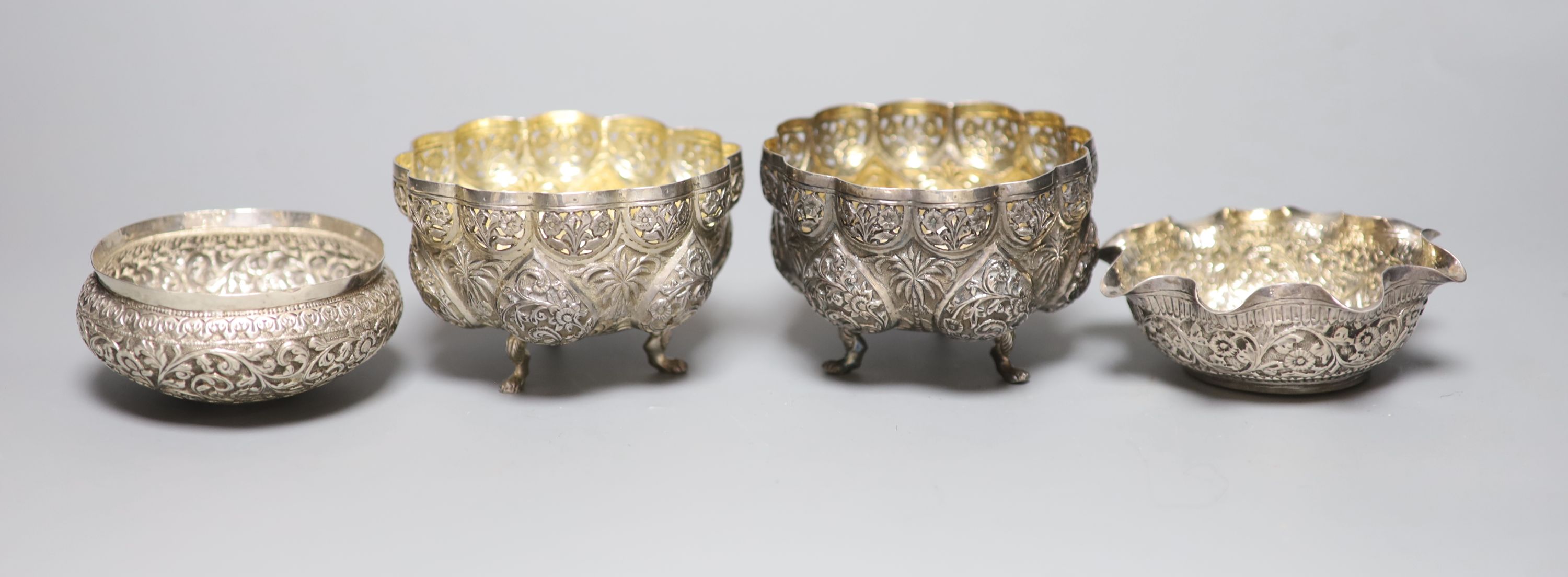 A pair of Indian white metal bowls, diameter 96mm and two similar bowls